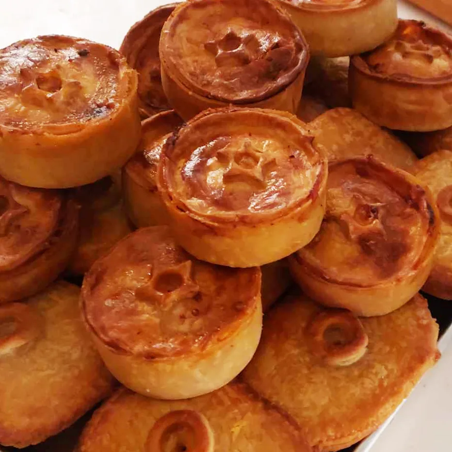 A fresh stack of golden pies on the counter.