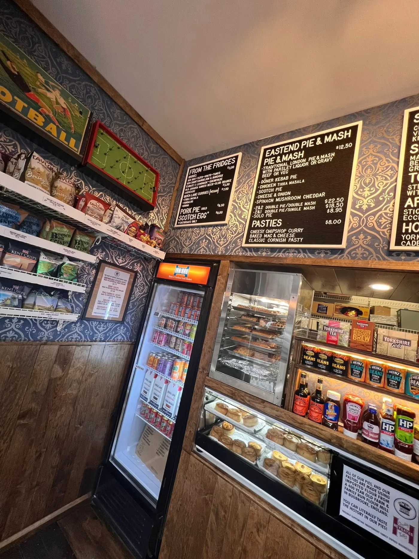 Inside Eastend Pie & Mash: menu boards, wooden trim and the pie warmer on Gerrard Street East.